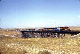 Great Northern Railway Train Number 32, Empire Builder, on steel trestle bridge at Cutbank, Monta...