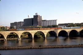 Great Northern Railway Western Star no 27 on stone arch bridge leaving Minneapolis, Minnesota dep...