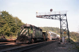 Burlington Northern diesel locomotive 2507 moves under a cantilever signal bridge at South Seattl...