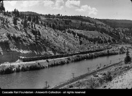A Milwaukee Road boxcab locomotive set along the Yakima River in Washington, undated.
