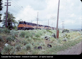 Milwaukee Road diesel locomotive Number 5009 leading a freight train at Boylston, Washington, und...