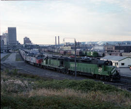 Burlington Northern diesel locomotive 2520 assist Amtrak power at Tacoma, Washington, in 1979.