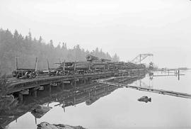 Log Train at Weyerhaeuser Company Pier at South Bay, Washington in April 1976.