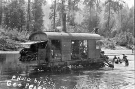 A steam donkey being moved across a river in Lewis County, Washington, circa 1900.