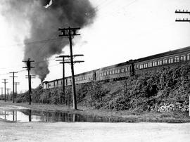 Northern Pacific steam locomotive leads a passenger train at Black River, Washington, circa 1941.