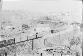 A Southern Pacific Railroad passenger train and freight train pass at Colfax, California, circa 1925